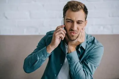 man scheduling an emergency dental appointment at Sycamore Family Dentistry