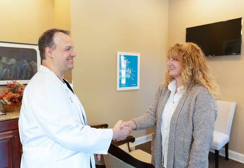 Dr. Jacob Sheppard speaking with a senior patient about family dentistry at Sycamore Family Dentistry in VA